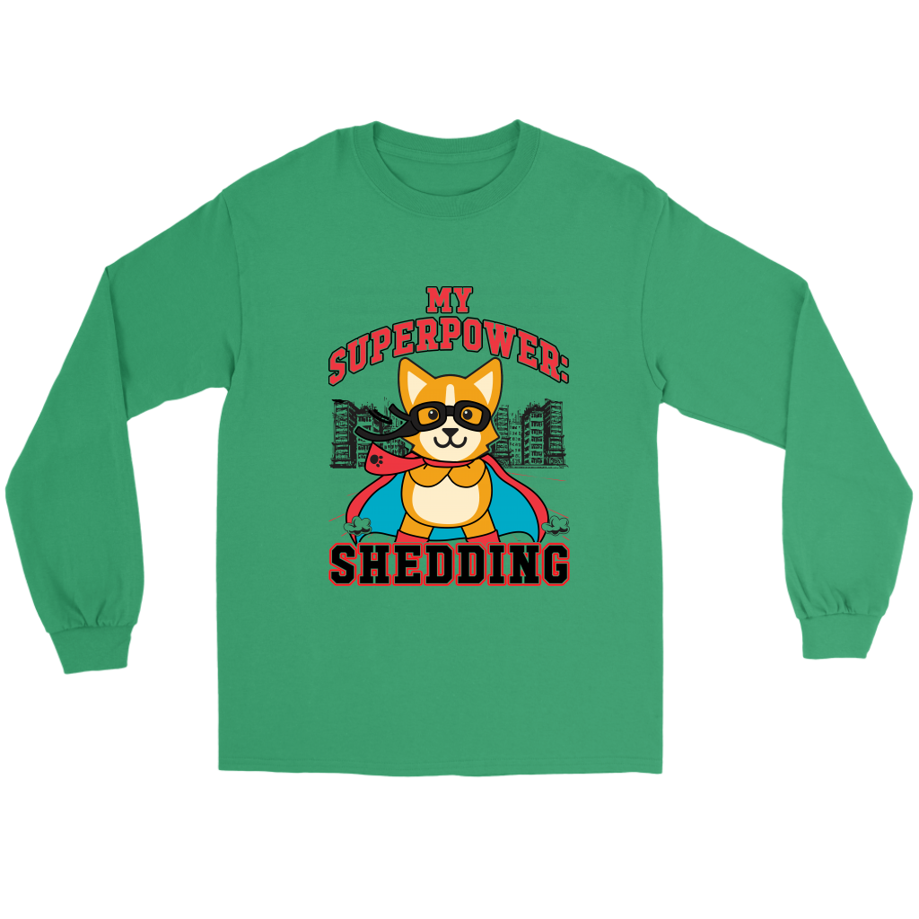 A flay lay of a long sleeved t shirt that is green and has red and black text that says "My superpower: Shedding" with a corgi dressed as a superhero.