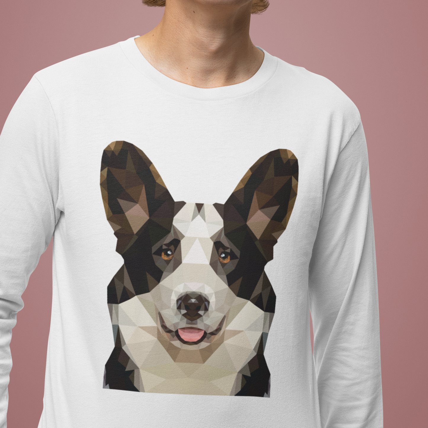 A model wearing a white long sleeved t shirt with a polygonal cardigan corgi's face on it. 