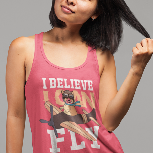 A model wearing a racerback tank top with the text "I believe I can fly" with a picture of a corgi in a biplane. The tank top is raspberry colored.