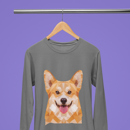 A long sleeved t shirt hanging from a wooden hanger on a metal pole. The design of the shirt is polygonal pembroke corgi.