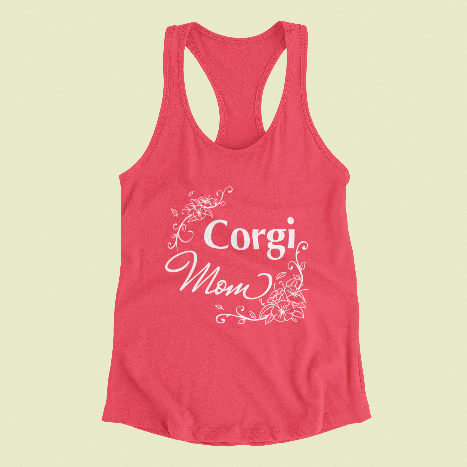 A racerback tank top, in coral pink color, with the text "Corgi Mom" with flower line art around it.