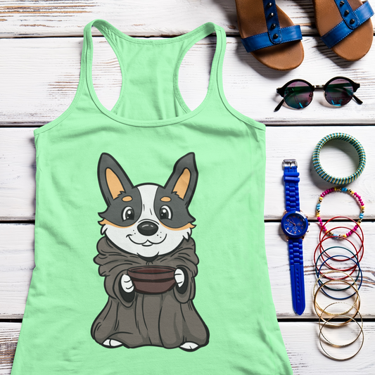 A flat lay of a racerback tank top with some summery accessories like sunglasses and bracelets. The tank top has a picture of a corgi dressed as baby yoda. The tank is mint green.