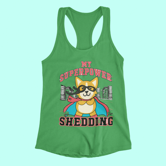 A flat lay of a racerback tank top that is green. The text on the top is red and black and it says "My Superpower: Shedding" and shows a corgi dressed as a super hero. 