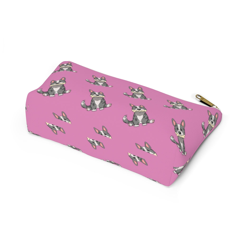 Pink make up bag with a pattern of a cardigan corgi holding a bone in its mouth, view from the bottom