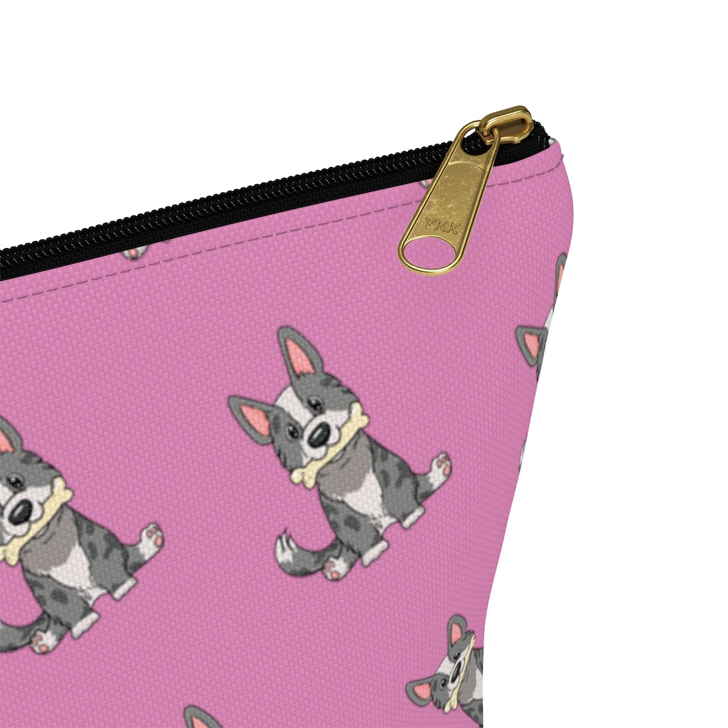 Pink make up bag with a pattern of a cardigan corgi holding a bone in its mouth, zoom in on zipper