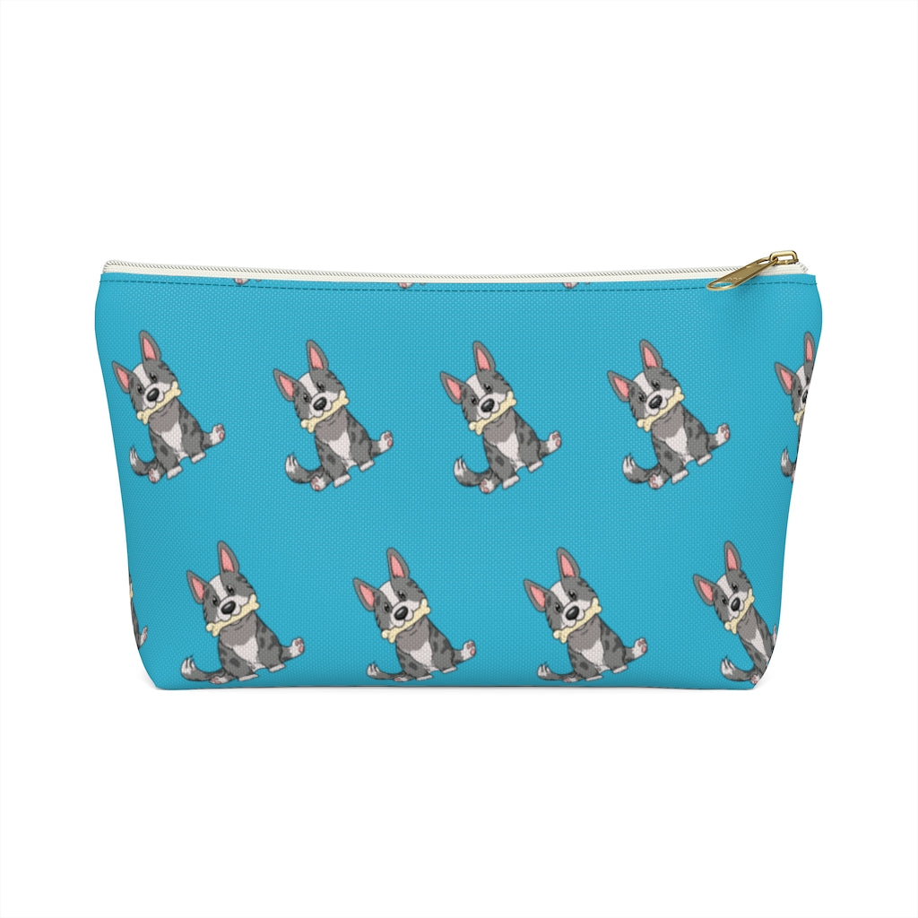 Blue make up bag with a pattern of a cardigan corgi holding a bone in its mouth. 