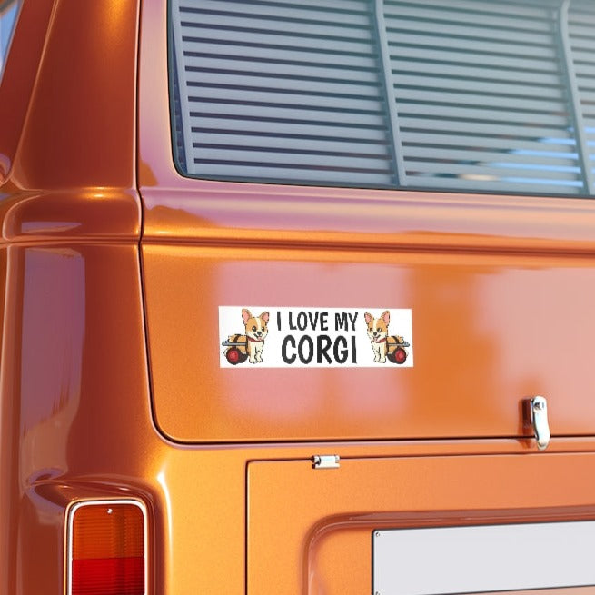 A bumper sticker that says "I love my corgi" with two pictures of corgis in wheelchairs. The bumpersticker is on the back of an orange van.