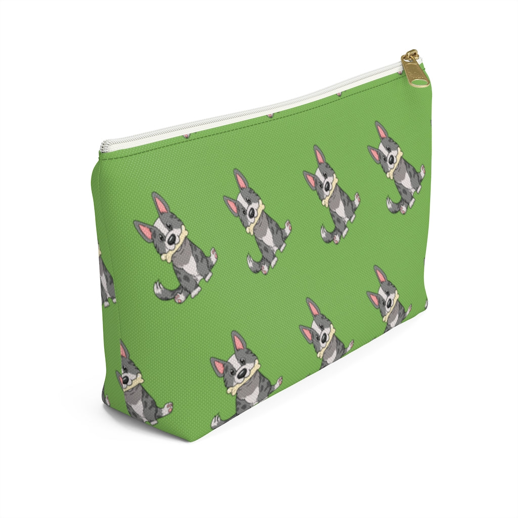 Green make up bag with a pattern of a cardigan corgi holding a bone in its mouth, view from the side