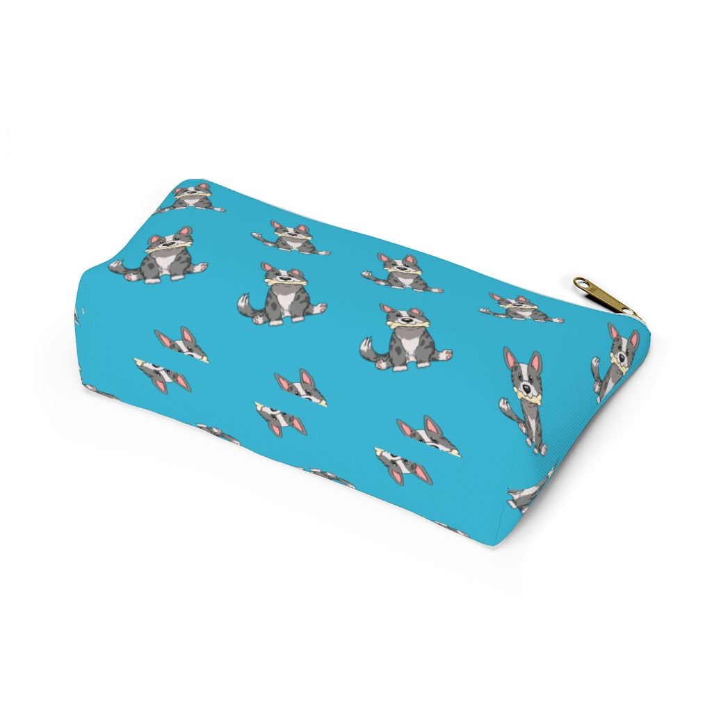 Blue make up bag with a pattern of a cardigan corgi holding a bone in its mouth, view from the bottom