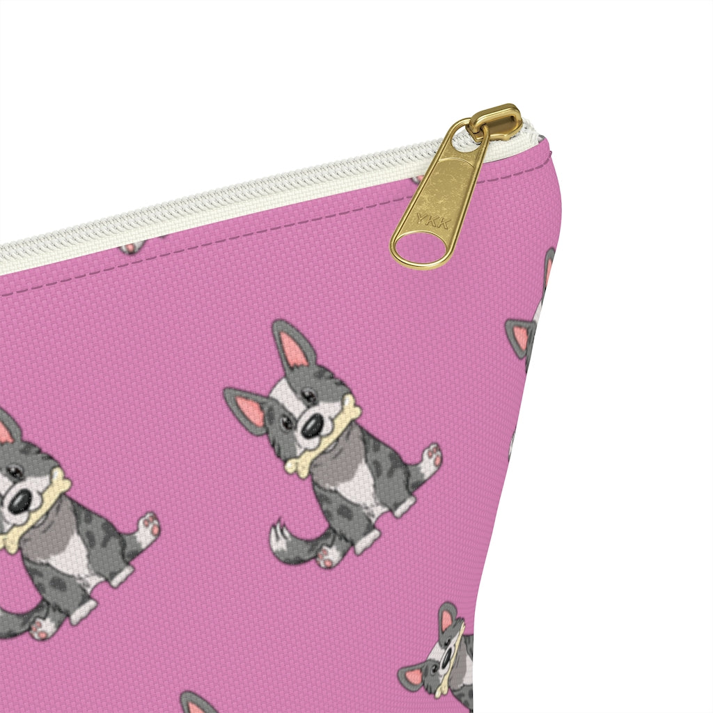 Pink make up bag with a pattern of a cardigan corgi holding a bone in its mouth, zoom in on zipper