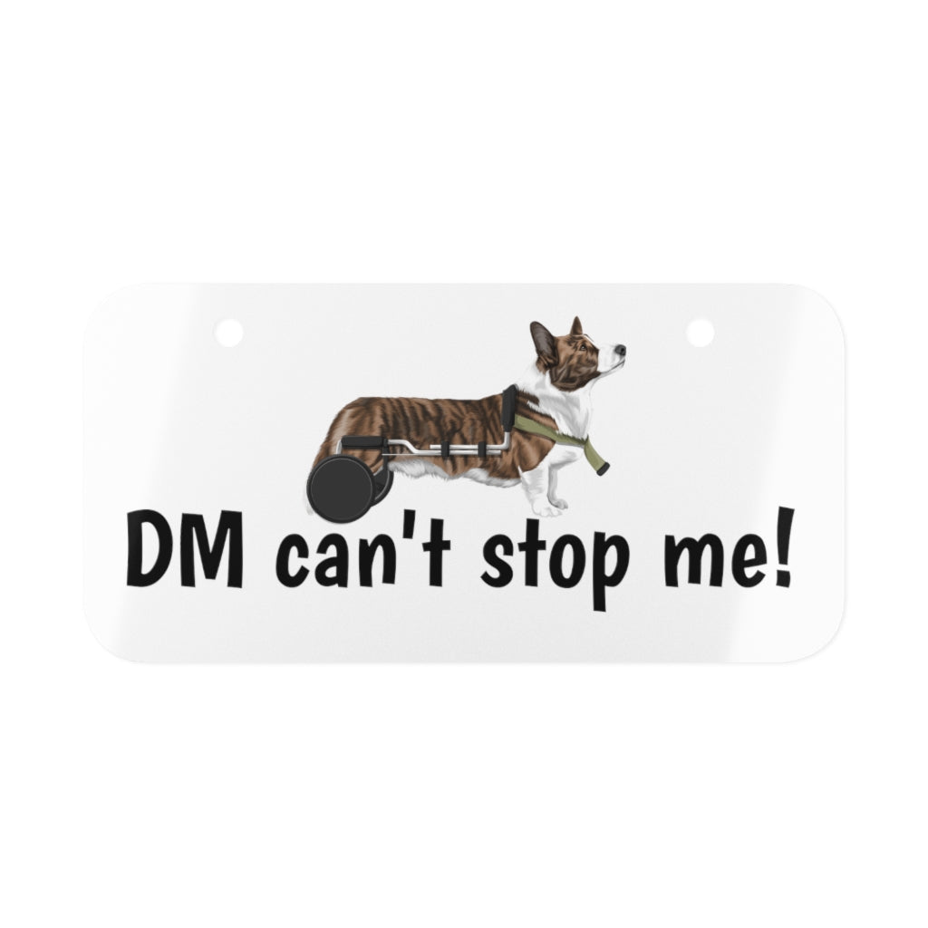 Our license plate with the text "DM can't stop me!" and a tricolor corgi in a wheelchair. 