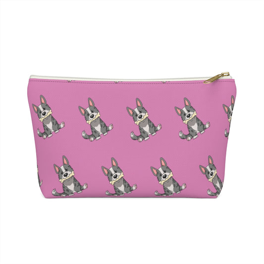 Pink make up bag with a pattern of a cardigan corgi holding a bone in its mouth, view from the side