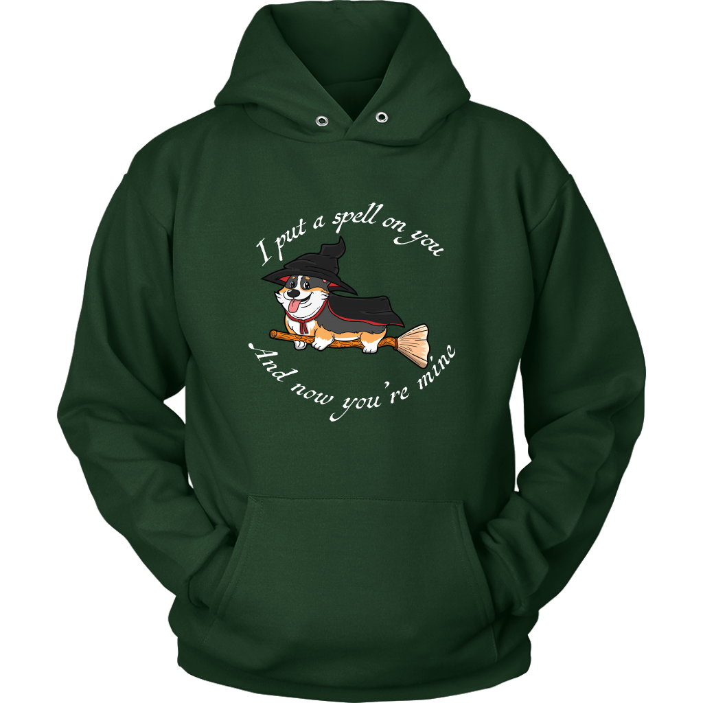 A hoodie with a corgi dressed as a witch with the text "I put a spell on you and now you're mine". The hoodie is dark green. 