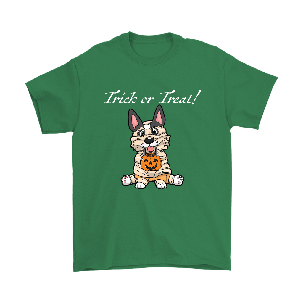 A t shirt with a tricolor corgi wearing a mummy costume. The text says "Trick or Treat" and the shirt is green.