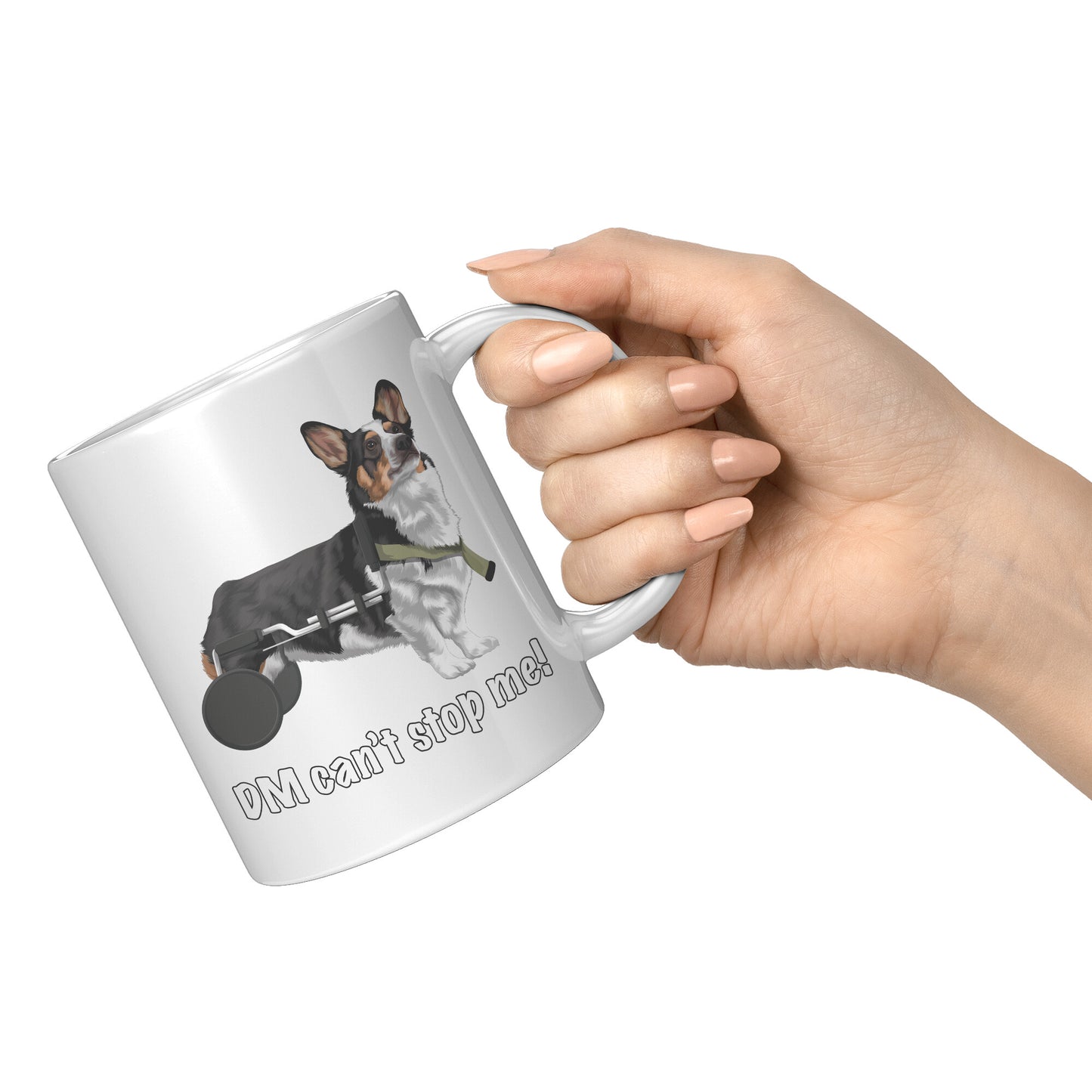 A hand holding the handle of a white coffee mug. The design on the mug is a tricolor corgi using a dog wheelchair.  The black-outlined text says "DM can't stop me".