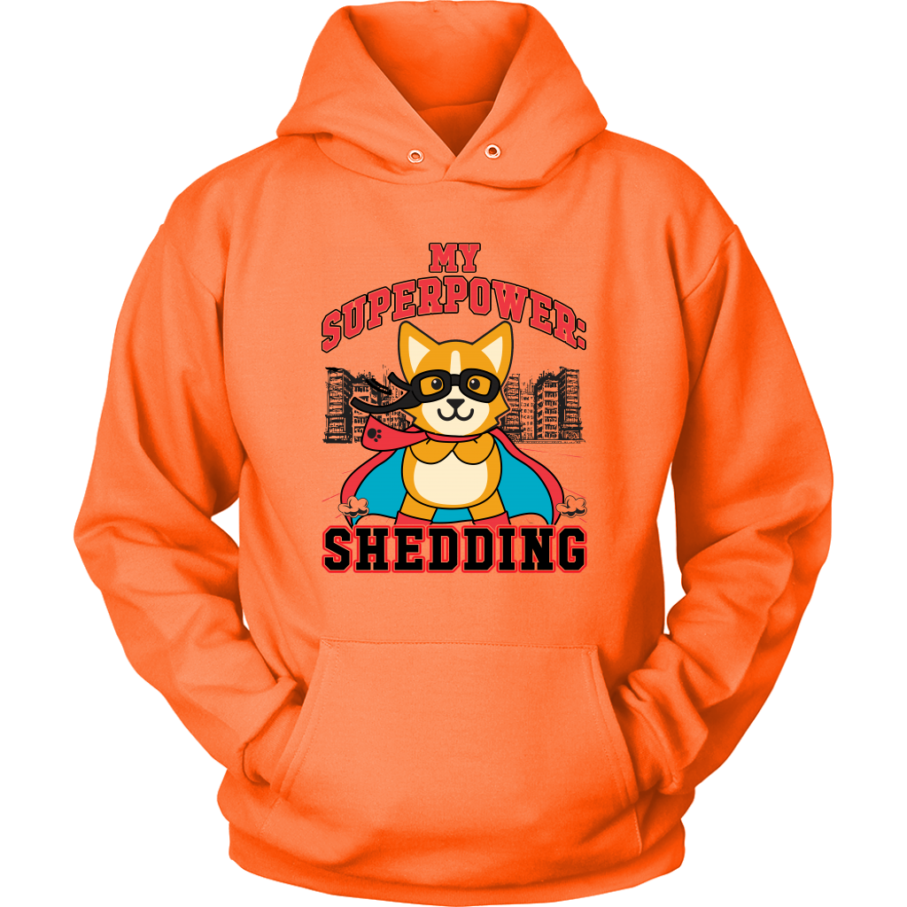 A flay lay of a hoodie that is orange and has red and black text that says "My superpower: Shedding" with a corgi dressed as a superhero. 