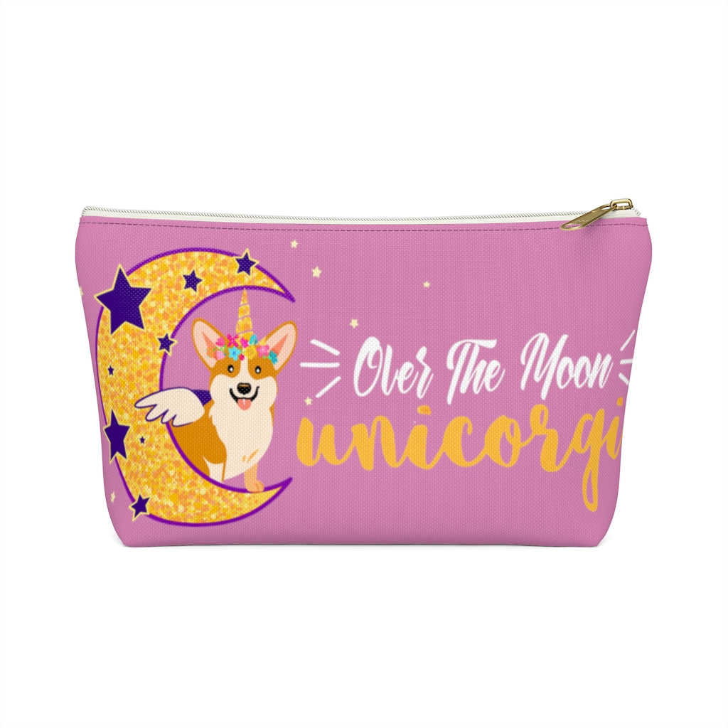 A pink make up bag with a corgi that has a unicorn horn and wings, sitting on the moon. The text says "Over the moon Unicorgi". 