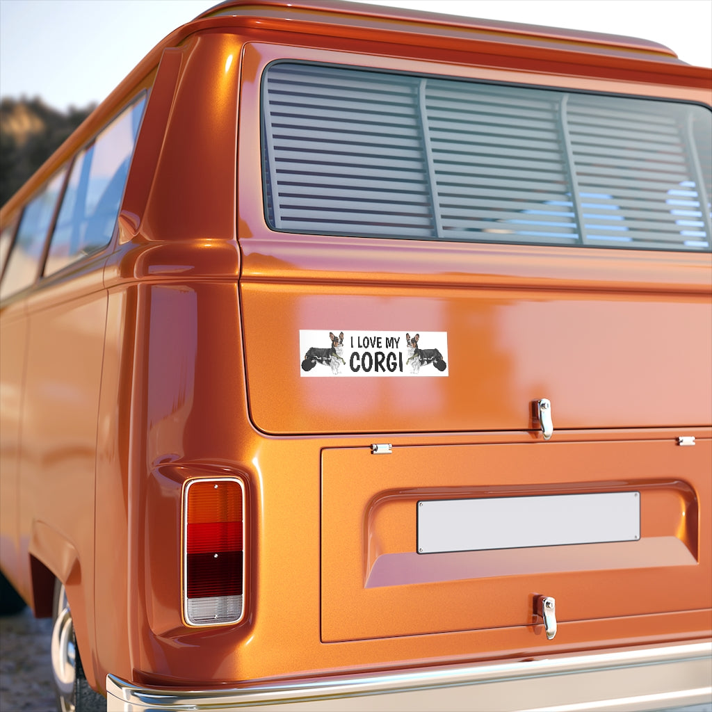 An orange van with a bumpersticker: A bumper sticker that has the text "I love my corgI' that is flanked by two tricolor corgis in wheelchairs.