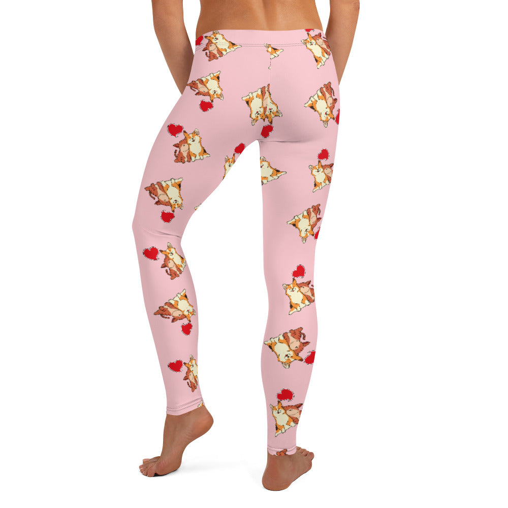 A model wearing pink leggings with a pattern of a corgi and a cat snuggling.