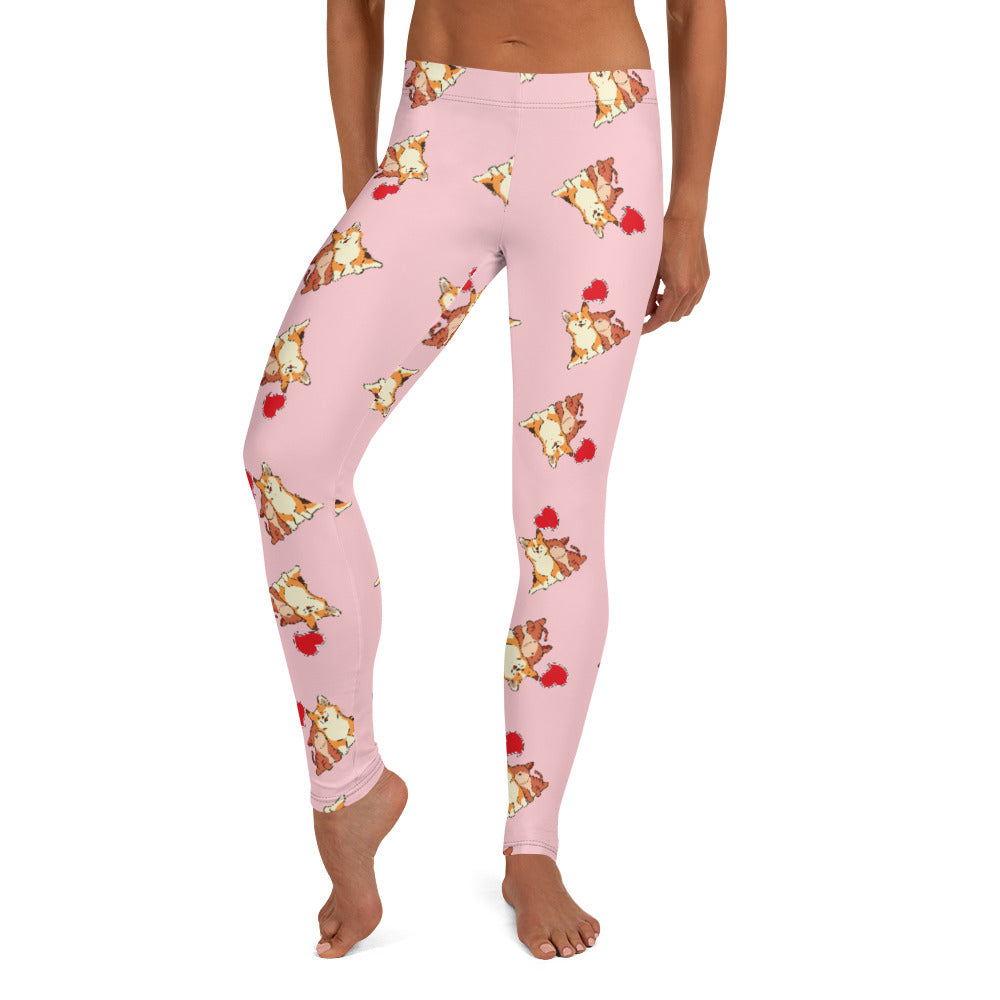 A model wearing pink leggings with a pattern of a corgi and a cat snuggling.