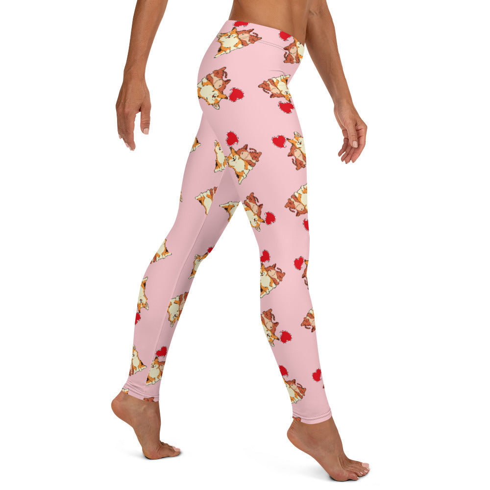 A model wearing pink leggings with a pattern of a corgi and a cat snuggling.