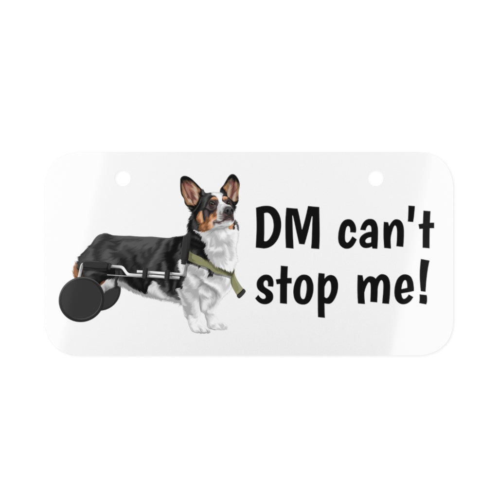 Our license plate with the text "DM can't stop me!" and a tricolor corgi in a wheelchair. 