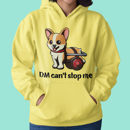 A model wearing a hoodie. The design of the hoodie is a fawn, smiling corgi in a doggie wheelchair. The text below the corgi is "DM can't stop me". The hoodie is yellow colored. 