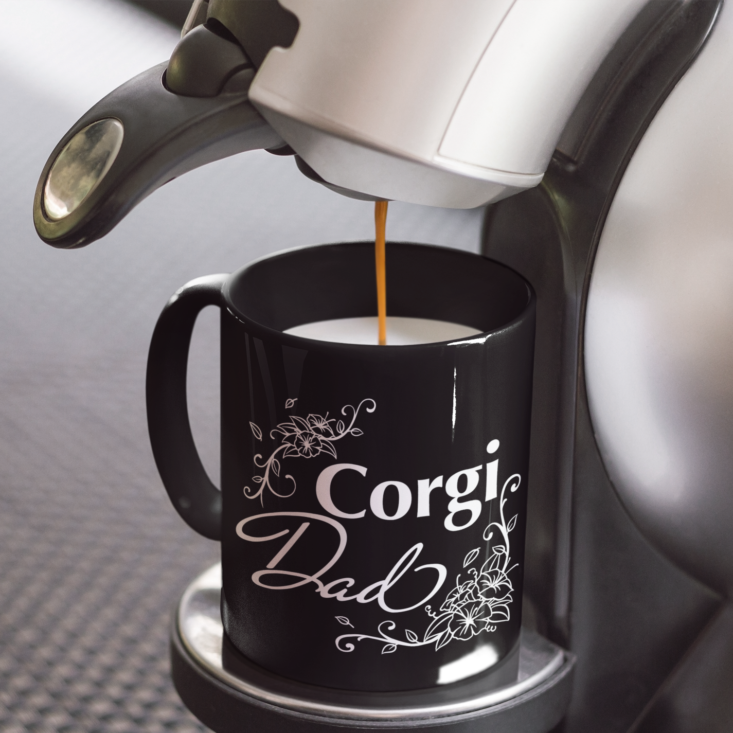 Black mug with flowery "Corgi Dad" text.