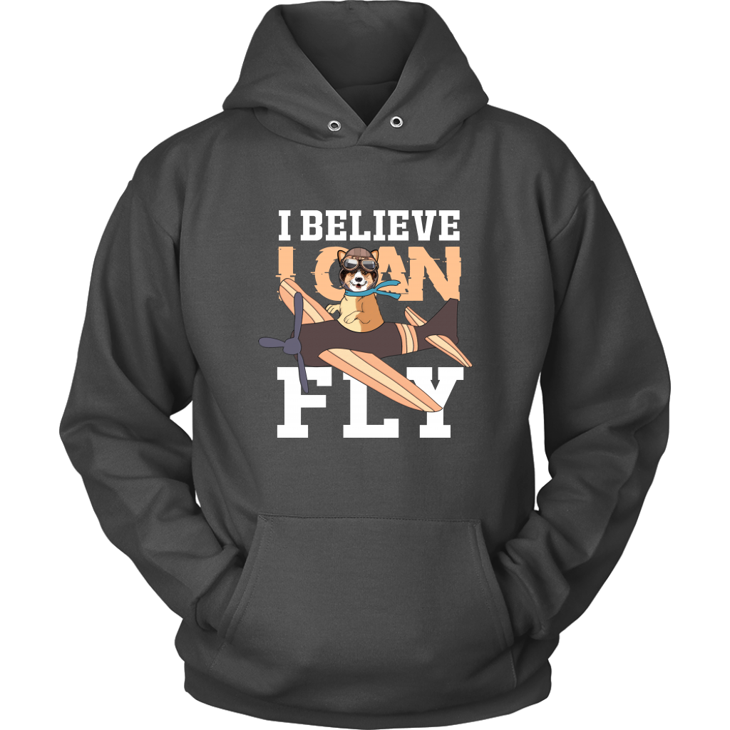 A flat lay of a dark grey hoodie that has a corgi flying a play with the text "I believe I can fly".