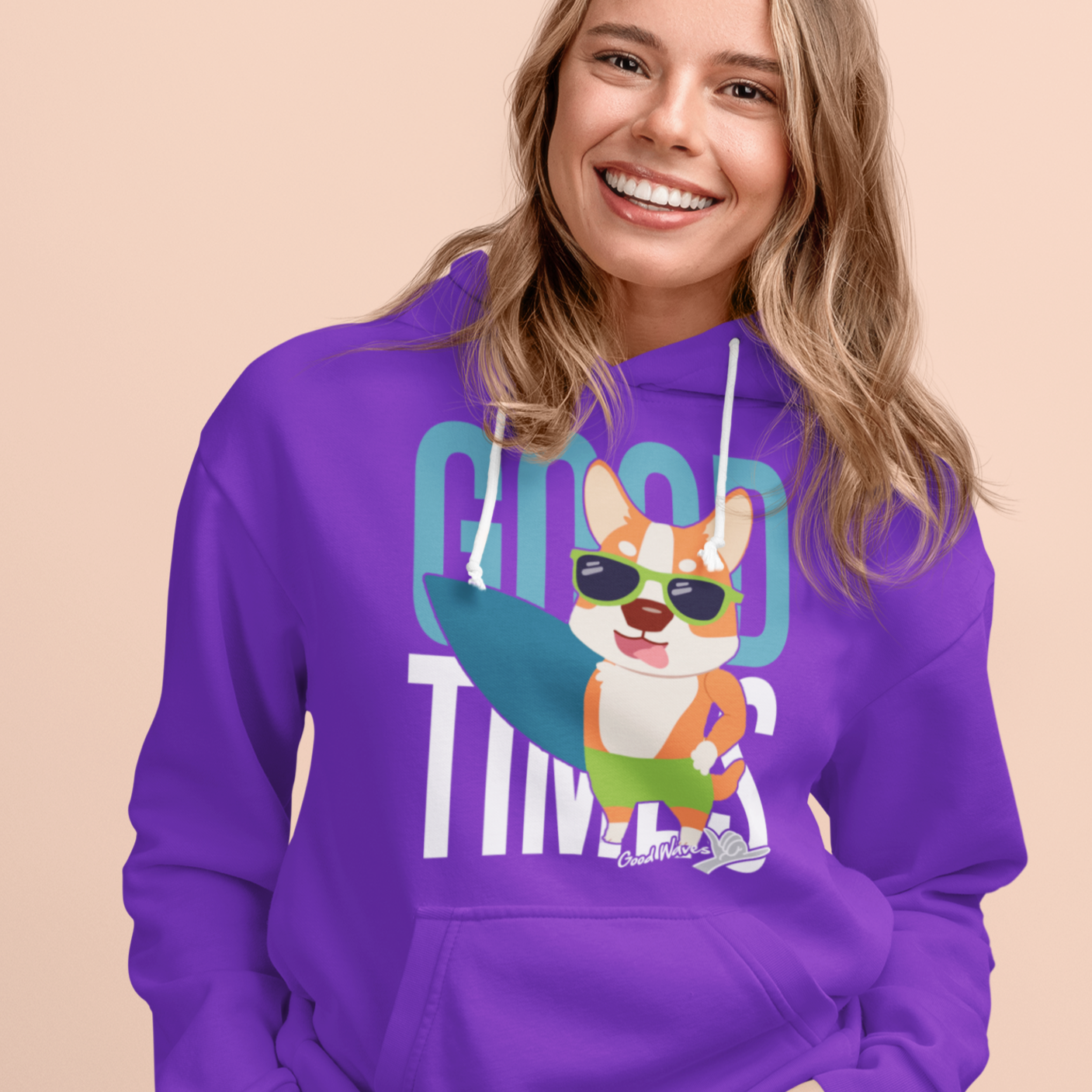 A model wearing a hoodie with the text "Good times" with a happy corgi holding a surf board. The hoodie is purple. 