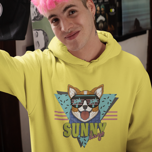 A model wearing a hoodie with the text "Sunny Days" and a corgi in sunglasses. The hoodie is yellow colored.