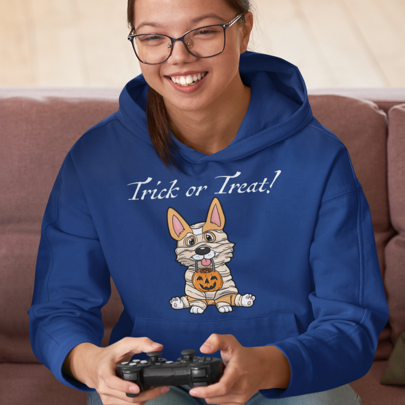 A model wearing our "Trick or Treat!" Hoodie while playing a video game. 