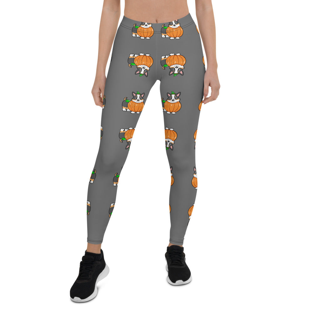 A woman modeling our pumpkin Tricolor Halloween Leggings. The pattern is a tricolor corgi wearing a pumpkin costume.