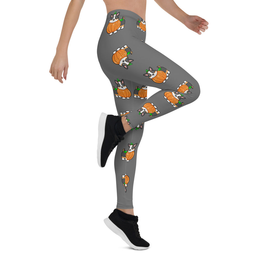 A woman modeling our pumpkin Tricolor Halloween Leggings. The pattern is a tricolor corgi wearing a pumpkin costume.