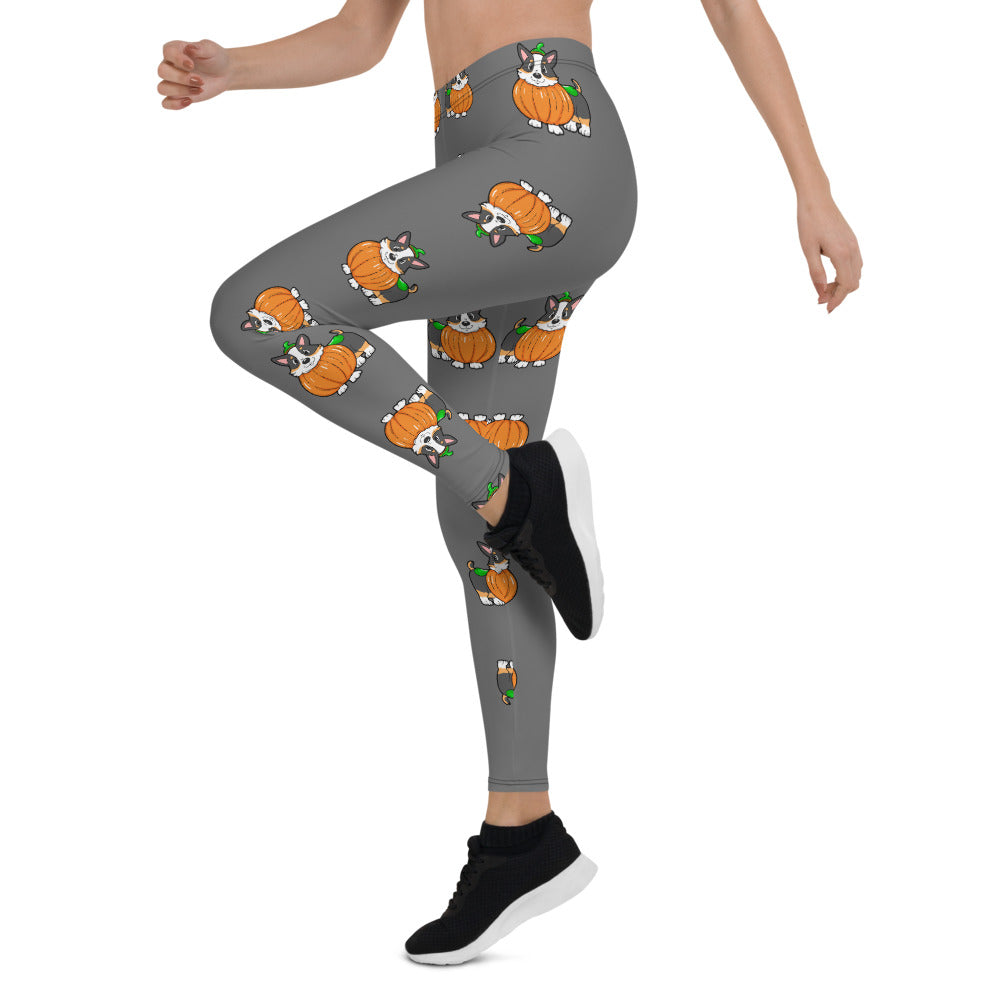 A woman modeling our pumpkin Tricolor Halloween Leggings. The pattern is a tricolor corgi wearing a pumpkin costume.