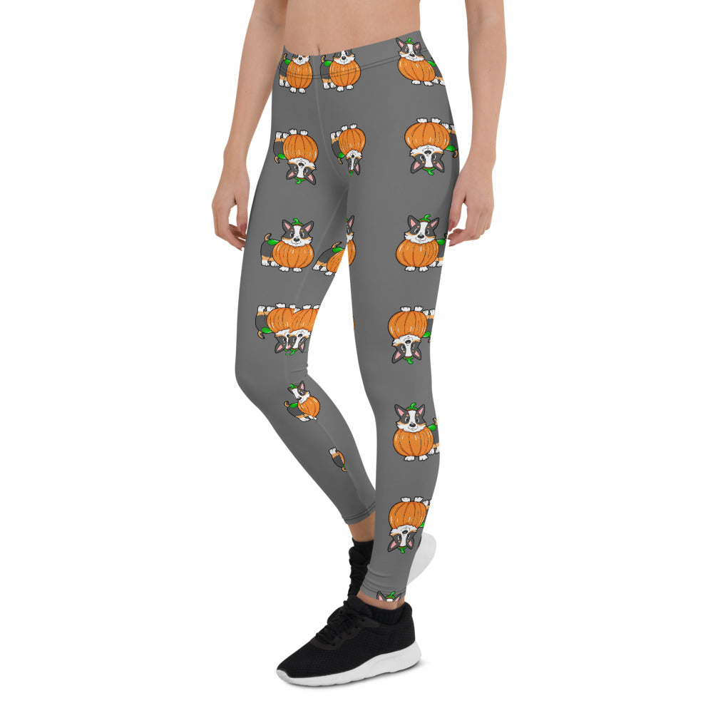 A woman modeling our pumpkin Tricolor Halloween Leggings. The pattern is a tricolor corgi wearing a pumpkin costume.