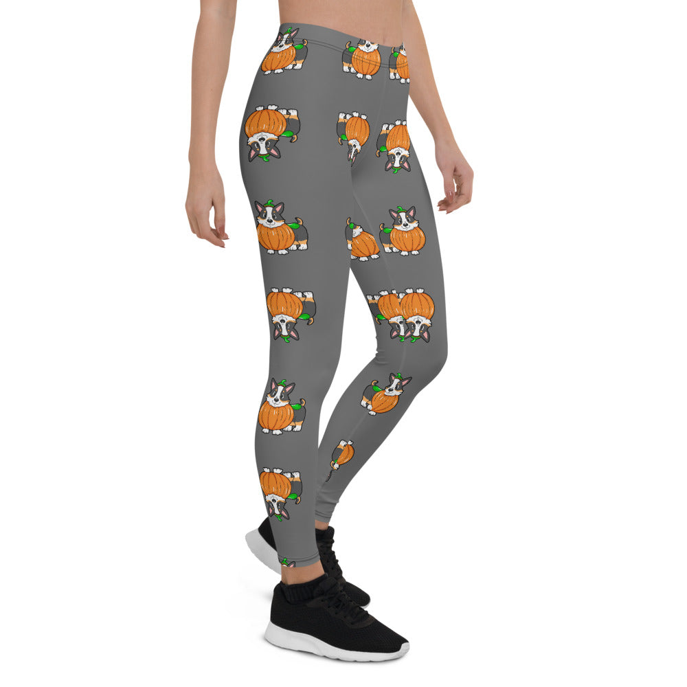 A woman modeling our pumpkin Tricolor Halloween Leggings. The pattern is a tricolor corgi wearing a pumpkin costume.