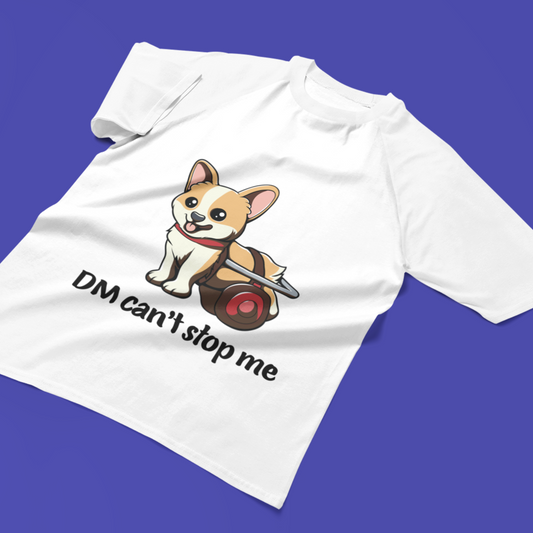 T shirt laying flat on a background that's purply-blue. The shirt is white and shows a corgi in a wheelchair with the text "DM Can't stop me".