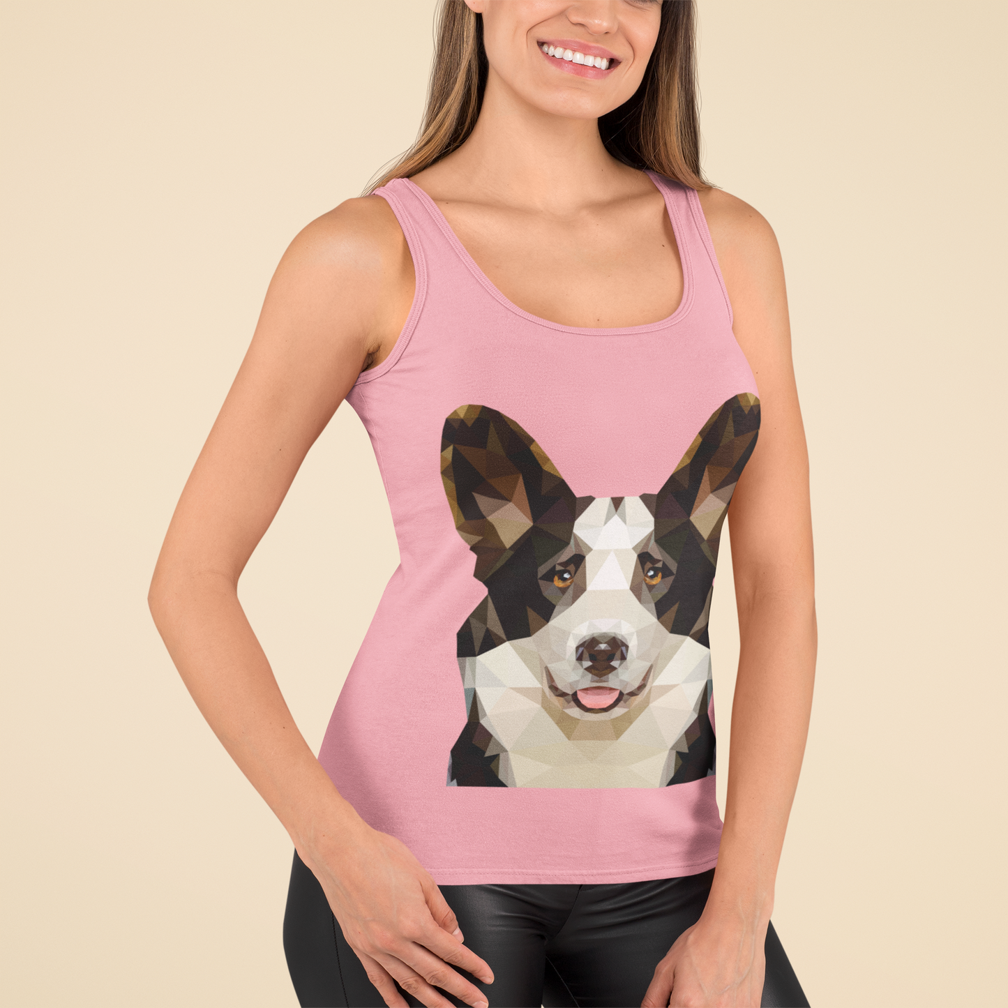 A model wearing a racerback tank top with a cardigan corgi made of polygonal art. The tank is pink.