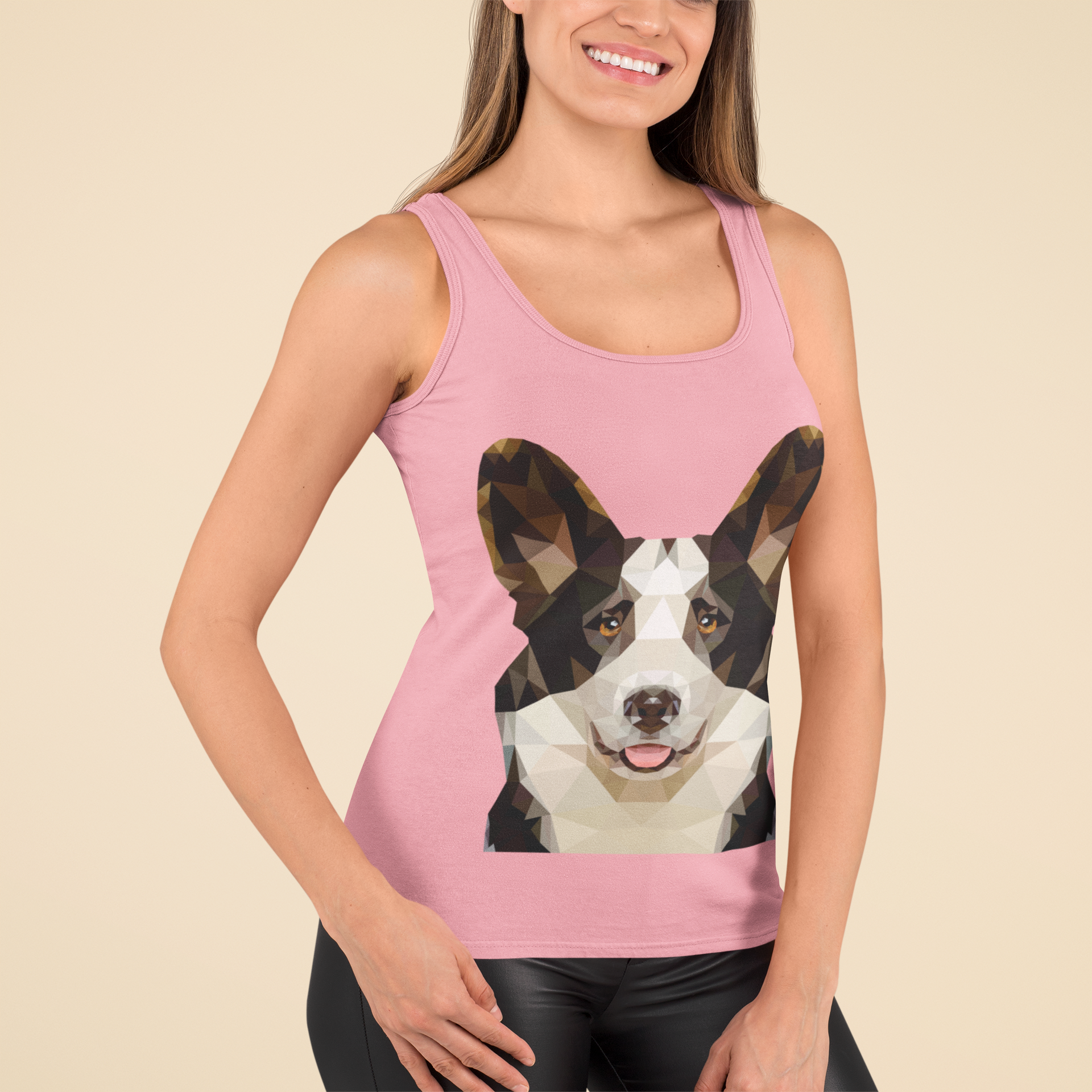 A model wearing a racerback tank top with a cardigan corgi made of polygonal art. The tank is pink.