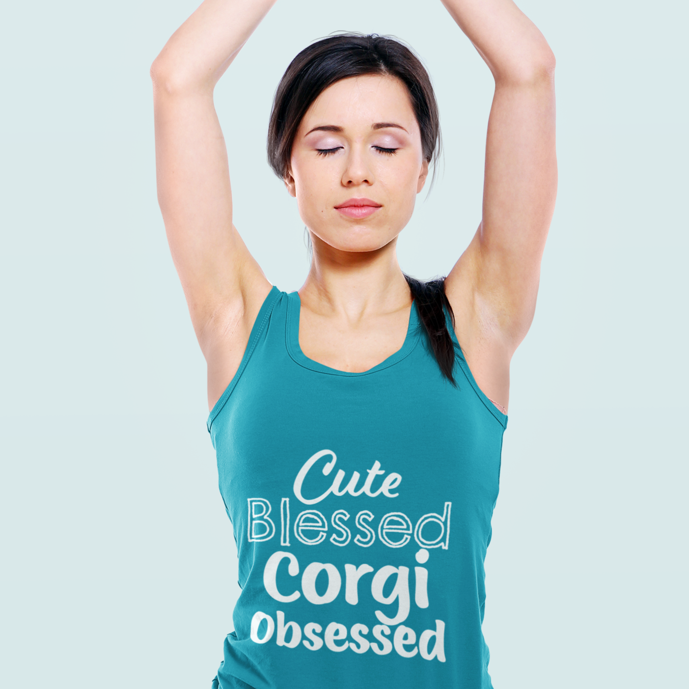 A model wearing a teal colored racerback tank top. The tank top says "Cute blessed Corgi Obsessed".